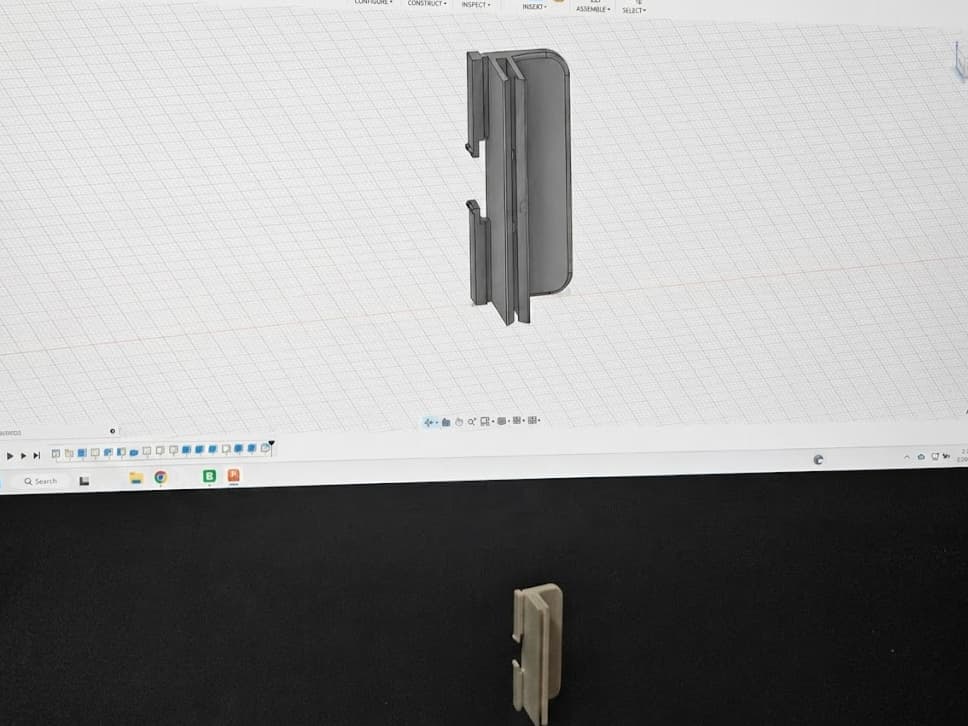CAD model on screen above the matching 3D-printed part